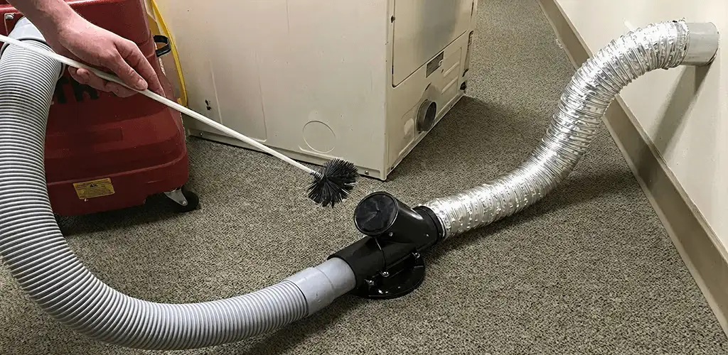 Dryer vent cleaning service removing lint from a dryer duct connection in Orange, CA