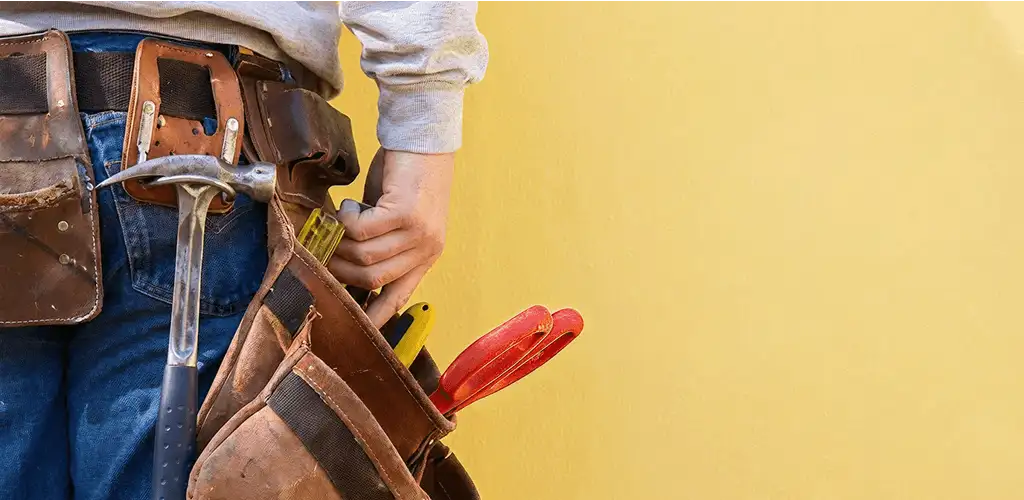 Handyman with tool belt ready for home repairs and maintenance in Orange, CA