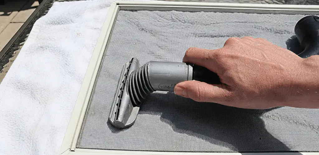 Window screen repair cleaning and fixing a damaged screen mesh in Orange, CA